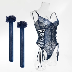 Close-up of deep blue lace bodysuit with ribbon lacing and matching mesh stockings