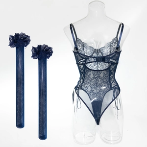 Detail of dark blue lace bodysuit with intricate mesh patterns and matching stockings