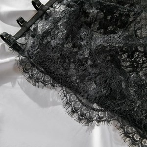 Close-up of black eyelash lace detail and mesh patterns with adjustable shoulder straps