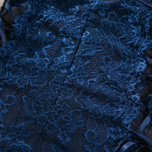 Detailed macro view of dark blue floral lace with criss-cross ribbon lacing on bodysuit