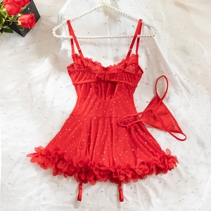 Detail of red lace lingerie set with sequins and garter straps on white silk