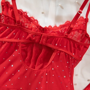Detail of red lace bodysuit with shimmering rhinestones and eyelash lace trim