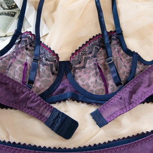 Detail of purple leopard print mesh lace bra with blue satin straps and metal buckles