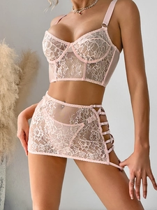 Three-piece light pink lace lingerie set with underwired camisole top and cutout skirt
