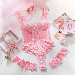 Detailed view of pink floral lace bodysuit set with matching leg bands and bow accents