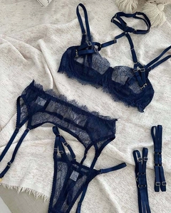 Close-up of deep blue lace bra with intricate eyelash trim and metal hardware details