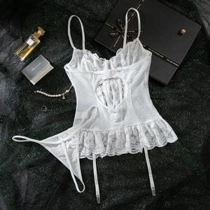Detailed flat lay of white lace lingerie set with heart-shaped cutout and garter straps
