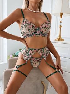 Detailed pink floral embroidery on sheer mesh lingerie set with forest green satin trim