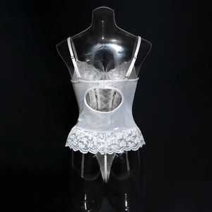 Close-up of white lace bodysuit with heart-shaped back cutout and floral mesh detail