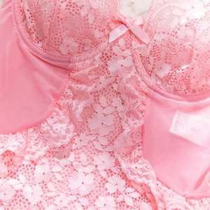 Close-up of pink floral lace bodysuit detailing exquisite mesh texture and size S tag