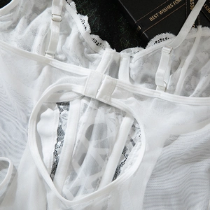 Detailed view of white lace bodysuit back with heart-shaped cutout and sheer mesh details