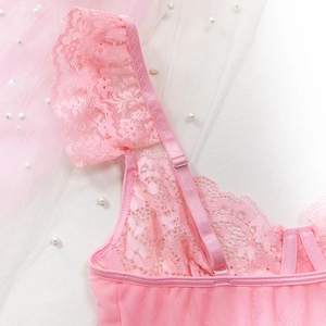 Detailed macro view of pink lace shoulder straps with silver buckles on sexy bodysuit