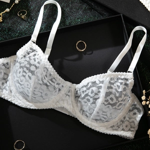 Detail shot of white lace bra with leopard pattern and underwire on a gift box