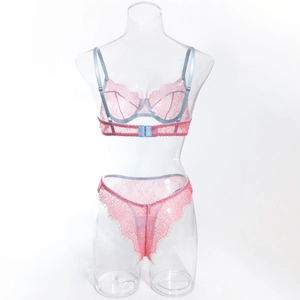 Detail of pink floral lace lingerie set with light blue straps and scalloped edges