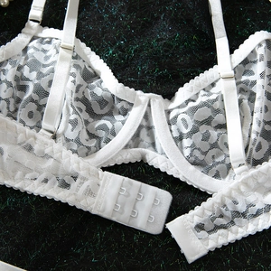 Detail shot of white leopard lace bra featuring underwire support and adjustable straps