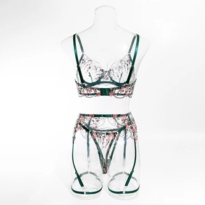 Detailed dark green floral embroidery on transparent mesh lingerie with satin straps
