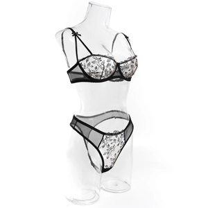 Detailed view of floral embroidery on a black mesh underwire bra and matching thong set