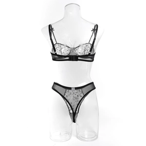 Detailed view of black floral embroidery and lace texture on underwire bra set