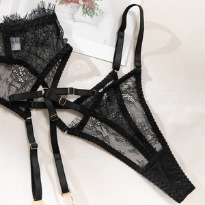 Detailed view of floral eyelash lace lingerie set with gold metal buckles and elastic straps