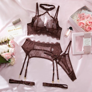 Flat lay of brown eyelash lace lingerie set with silk background and floral accents