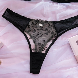 Detailed view of black floral embroidery and lace on sexy mesh thong underwear