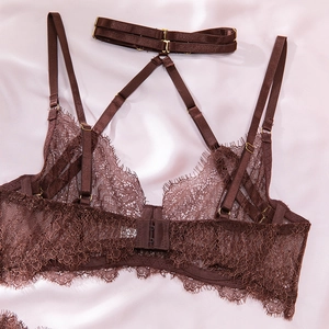 Detail of dark brown eyelash lace bodysuit back with adjustable straps and gold hooks