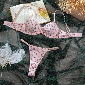 Detailed view of pink floral lingerie set with cherry print on fine ribbed fabric textures