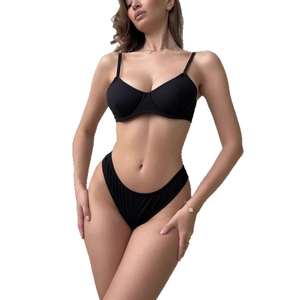 Minimalist black cotton lingerie set with wired bra and high cut briefs on white background
