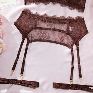 Detail of coffee brown lace garter belt with adjustable straps and gold metal hardware