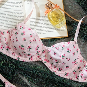 Detail of pink floral bra showing ribbed texture and red flower pattern on underwire fabric