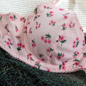 Detail of pink ribbed lingerie fabric with cherry print and wavy stitching craftsmanship
