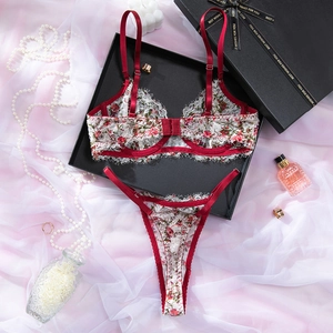 Détail à plat d'un ensemble de lingerie en dentelle florale avec bretelles en satin