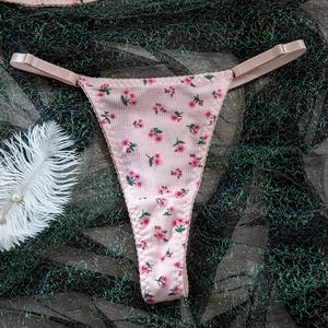 Detail of pink floral thong with ribbed fabric and adjustable side straps on lace