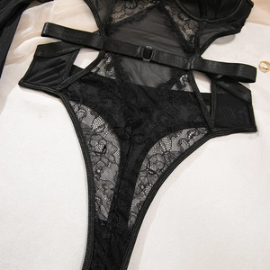 Detailed view of black floral lace bodysuit with mesh panels and strap details