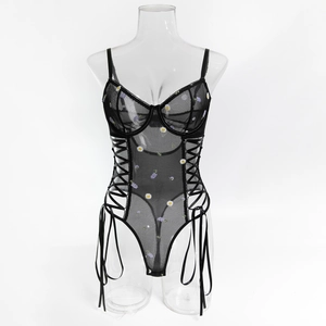 Detail view of black sheer mesh bodysuit with floral embroidery and side lace-up ties