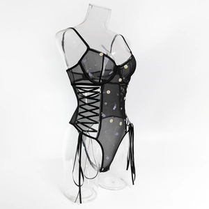 Detailed embroidery of daisies and purple flowers on a black sheer mesh bodysuit
