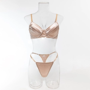 Detail view of champagne gold satin lingerie set with push-up bra and high-cut thong