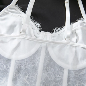 Détail de haut corset en dentelle blanche avec tissu en maille et bordure en dentelle cil