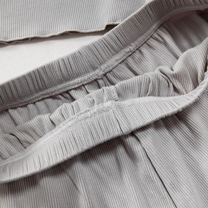 Dettaglio della trama in maglia a coste grigie e fascia elastica del set per il tempo libero