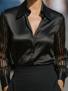 Detail of elegant black satin shirt featuring sheer striped mesh sleeves and classic polo collar