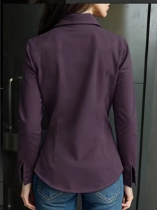 Detailed back view of dark purple long sleeve shirt with waist pleats and curved hemline