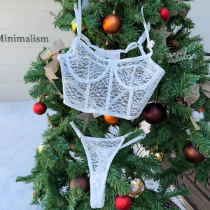 Detailed white leopard lace lingerie set with corset top and thong in Christmas setting