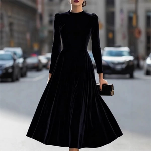 Elegant black velvet long sleeve midi dress with puff shoulders and a flared skirt