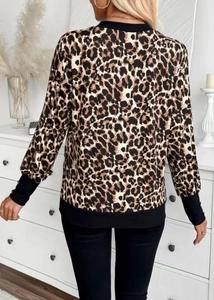 Detail of leopard print long sleeve top showing black ribbed cuffs and back view texture