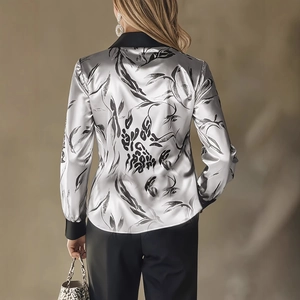 Elegant silver satin blouse with abstract leaf print and contrasting black collar cuffs