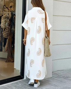 Detail showing the white shirt dress back with paisley print and side slit hem