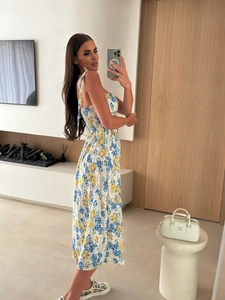 Detail of smocked waist floral maxi dress with blue yellow print and tie straps