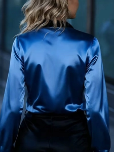 Rear view of long sleeve satin shirt in royal blue with black collar and silky texture