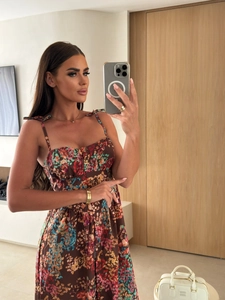 Detail view of the floral print sundress featuring a button-down front and bow shoulder straps
