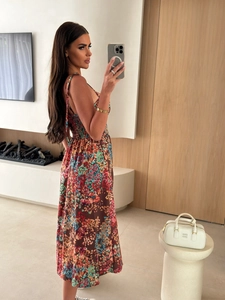 Detail of floral spaghetti strap maxi dress with elastic high waist and colorful print